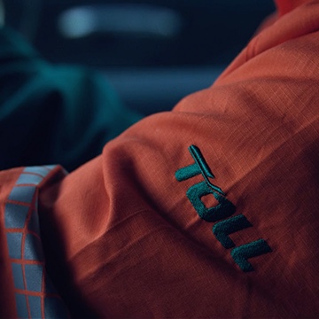 Close-up photo of the Toll arm patch on the uniform, displaying the design of the brand