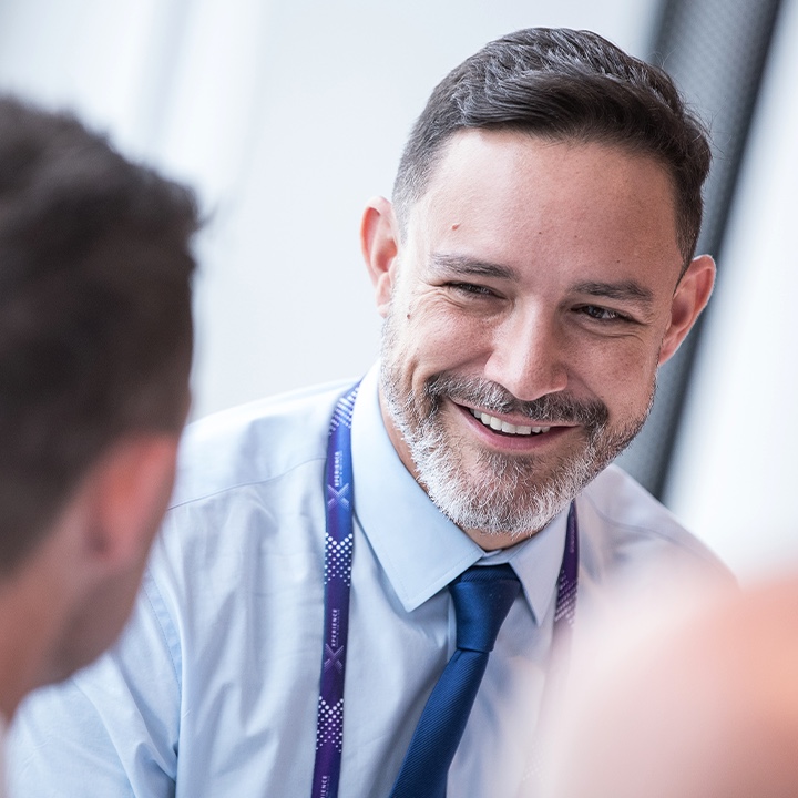 Friendly Volkswagen employee conversing with a customer which shows the personality of the Brand