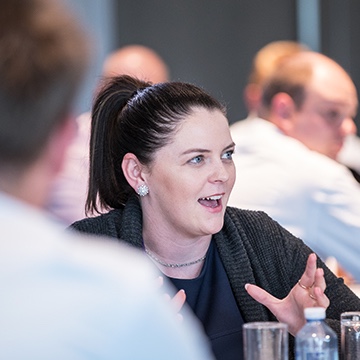 Woman speaking at the Volkswagen conference showing the employee-customer relationship