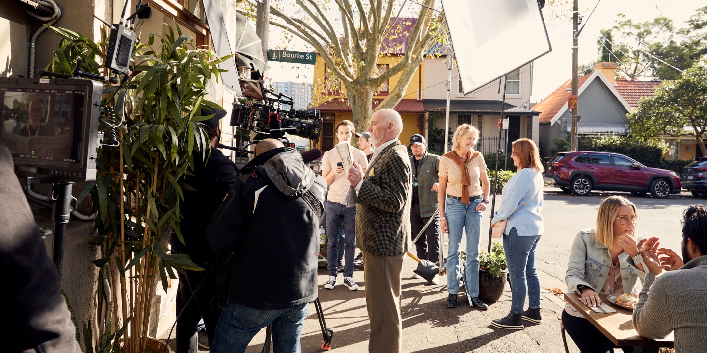 Behind the scenes shot of old chap with a newspaper on the Caleb & Brown shoot