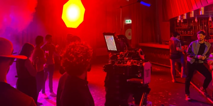 Behind the camera shooting talent at the bar for the Emen8 monkeypox campaign shoot.